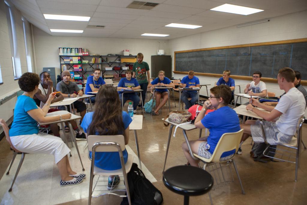 Students at desks that are in a circle.